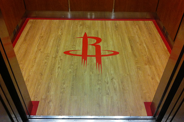 Luxury vinyl floor tile with inlays at the Houston Toyota Center.
